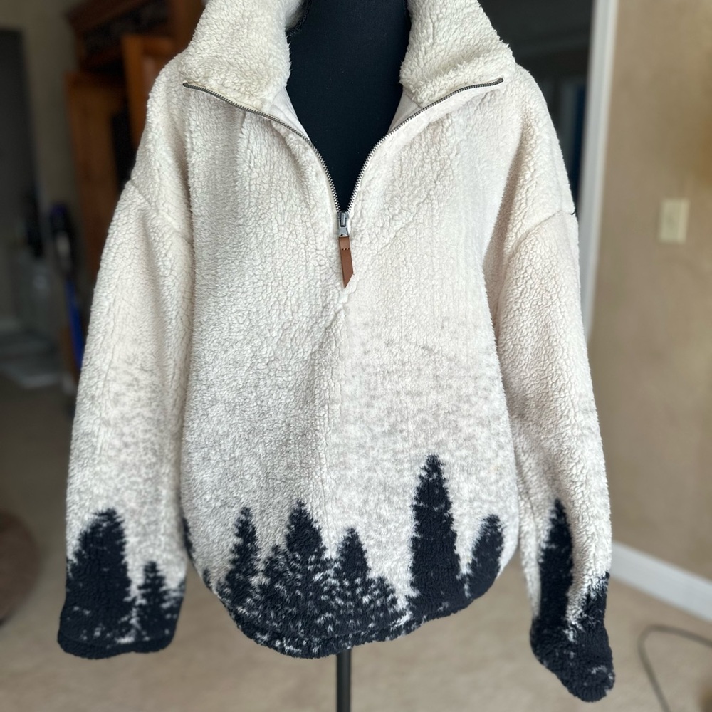 Thick fleece pullover with forest detail.